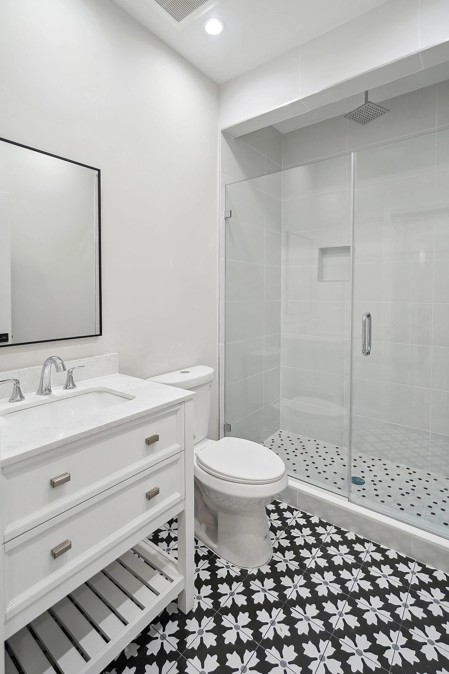Modern bathroom with white vanity, toilet, and shower enclosure. Gallery - Quality Home Distribution