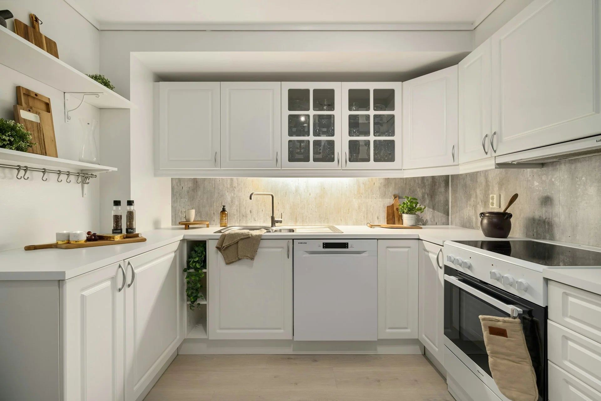 Modern kitchen with white cabinets, gray backsplash, and stainless steel appliances. Gallery - Quality Home Distribution
